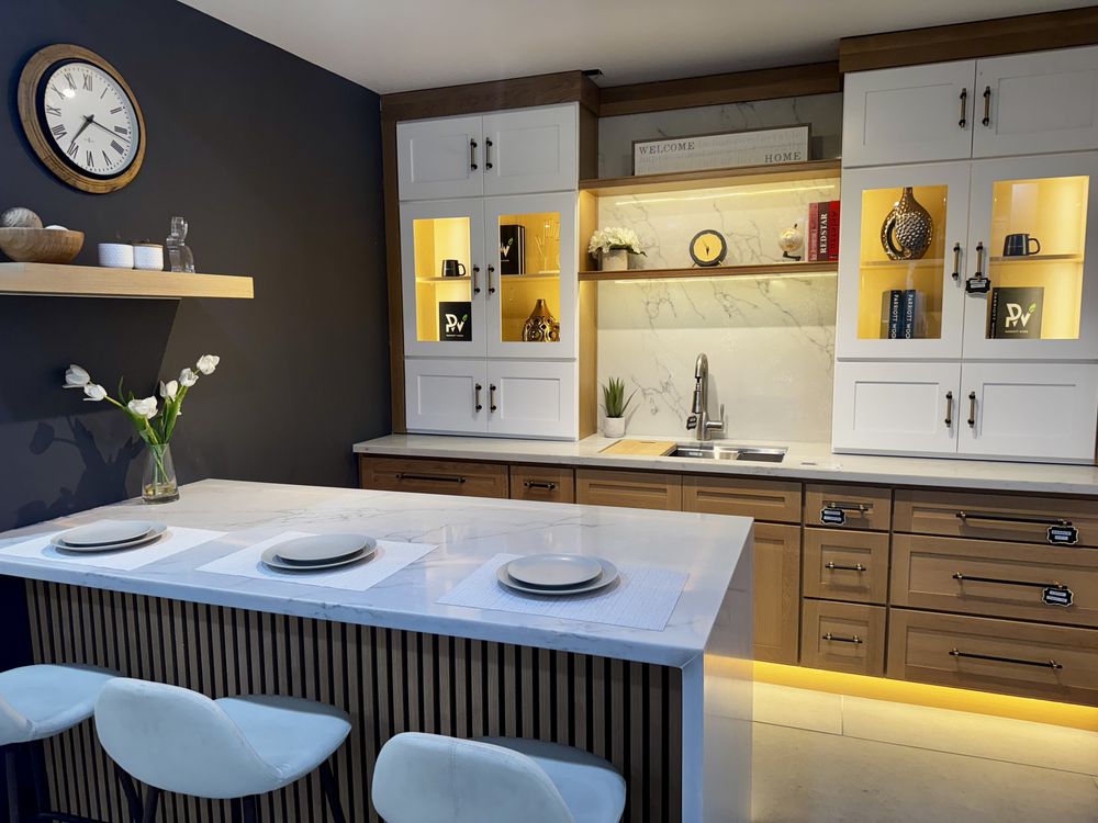 Custom kitchen with waterfall-marble island by SummitForge Construction