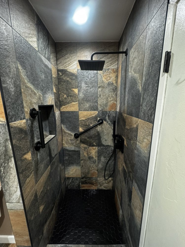Walk-in tile shower with matte-black fixtures by SummitForge Construction
