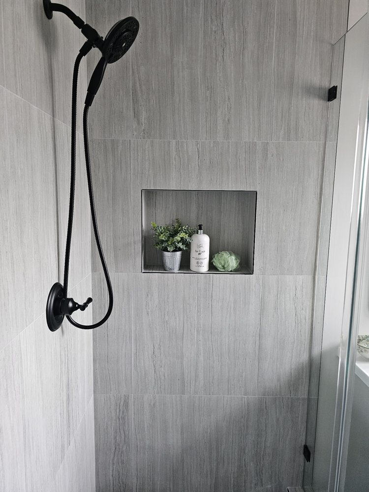 Walk-in tile shower with black fixtures by SummitForge Construction
