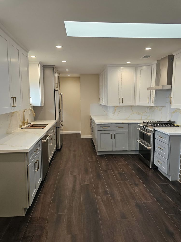 Galley kitchen remodel with calacatta countertops by SummitForge Construction