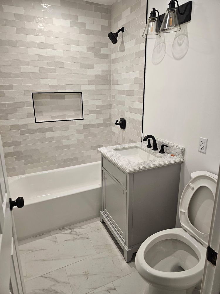 Bathroom remodel with subway tile and soaking tub by SummitForge Construction